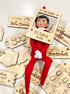 the elf is sitting on top of some wooden plaques