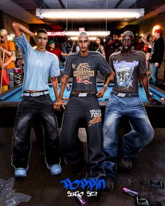 three men standing in front of a pool table