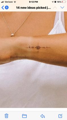 a woman's arm with a cross tattoo on the left side of her body