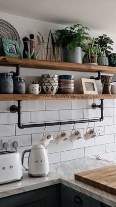 the kitchen counter is covered with pots and pans