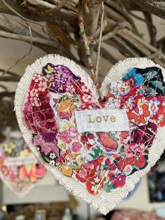 a heart shaped ornament hanging from a tree