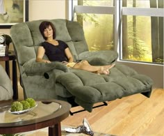 a woman sitting on a recliner in a living room