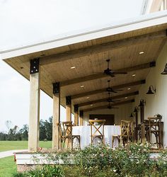 an outdoor covered patio with chairs and tables