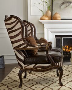 a zebra print chair sitting in front of a fire place