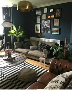 a living room filled with lots of furniture and pictures on the wall above it's coffee table