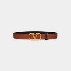 Valentino Garavani reversible calf leather belt. Approx. 1.1"W (3cm). Polished golden VLOGO buckle. Made in Italy. Bergdorf Goodman, Top Designers, Valentino Garavani, Leather Belt, Calf Leather, Tops Designs, In Italy, Buckle, Italy