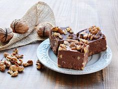 pieces of chocolate fudge cake on a plate with nuts