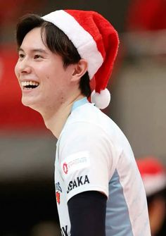 a young man wearing a santa hat and smiling