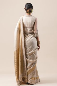 Ivory saree with all-over geometric motifs and hand embroidered border and gold-tone pallu. Paired with sheer sleeve blouse.
Component: 2
Embroidered
Neckline: Round
Sleeve Length: Three Quarter
Fabric: Munga Silk, Silk
Color: White
Sheer sleeves
Bead tassels - Aza Fashions Tarun Tahiliani Saree, Ivory Saree, Bead Tassels, Sarees Silk, Tarun Tahiliani, Embroidered Border, Embroidered Neckline, Saree With Blouse, Beaded Tassels