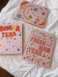 three children's books sitting on top of a white sheet covered in confetti