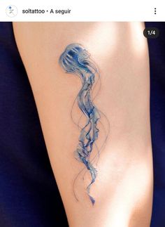 a woman's arm with a tattoo on it that looks like a jellyfish