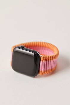 an apple watch band is shown on a white surface with pink and orange bands,