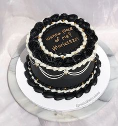 a black and white cake with writing on it