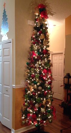 a decorated christmas tree in the corner of a room