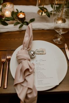 a place setting with silverware and napkins