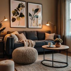 a living room with two pictures on the wall and a coffee table in front of it