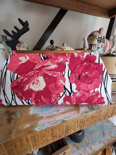 Gorgeous red flowered clutch handbag. This clutch is made from a designer line fabric printed in reds to dark pinks on a white background,  beige flower centers and black stems swirling in the background. The silver kiss lock hardware snaps open and closes securely. The lining is done in black with a nice sized pocket to hold a cell phone or other items like keys and lipstick.  The size of the clutch is 11 inches wide across the bottom,  8 1/2 inches across the top,  opens to 4 inches and is abo Red Clutch, Flower Center, Designer Fabric, Clutch Handbag, Flower Print, Red Flowers, Dark Pink, 11 Inches, Fabric Flowers