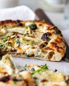 a close up of a slice of pizza on a table