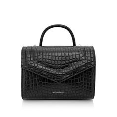 DELIVERY TIME 14-21 WORKING DAYS crocodile pattern handbag medium modern vegan bag top handle bag innovative fabric one pocket inside detachable medium-thick strap included stamped brand logo on the front made with care and attention to every detail locally crafted The FAITH MIDI Croco handbag, in classic black, showcases elegance and practicality. This crocodile pattern handbag suits various styles, from laid-back to formal. Made from innovative corn fabric, it's not only chic but eco-friendly. Midi Top, K Logo, K Logos, Vegan Bag, Medium Sized Bags, Vegan Handbags, Medium Handbags, Handbag Patterns, Vegan Bags