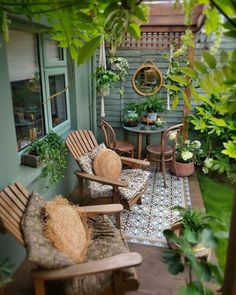 an outdoor patio with chairs, tables and potted plants