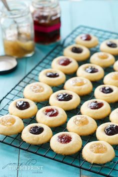 small cookies with jams on a cooling rack