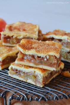 several pieces of dessert sitting on top of a cooling rack