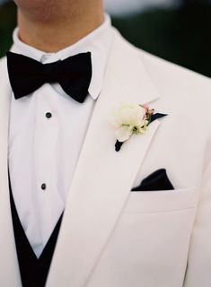 a man in a tuxedo with a boutonniere on his lapel