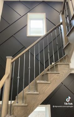 a stair case with metal handrails next to a window