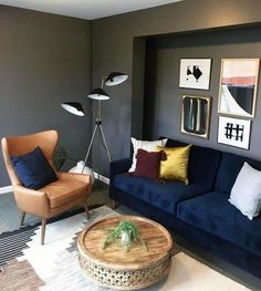 a living room filled with furniture and pictures on the wall