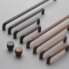 an assortment of handles and knobs on a white surface