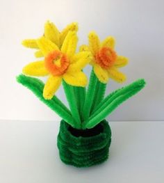 some yellow and orange flowers in a green vase