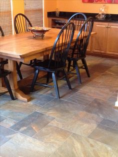 a kitchen table with four chairs around it