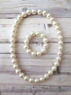 A pearl necklace and bracelet for toddlers and little girls. Great photo prop or just to dress up any outfits. This necklace is made of pearls acrylic beads and measures 15 inches long. The bracelet is 5 inches long. Please use with care and supervise children when wearing this necklace. It may pose choking or strangling hazards. By purchasing this listing, you are agree that Petite Peppermint will not be held responsible for any incidents that may happen of using this necklace. Get a combined s Baby Girl Necklace, Toddler Necklace, Necklace For Girls, Baby Necklace, Chunky Bead Necklaces, Girl Necklace, Baby Pearls, Big Pearl, Clasp Necklace