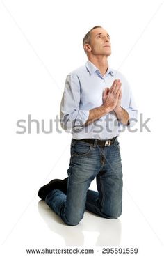 a man sitting on the ground praying