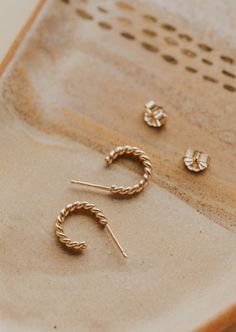 Ophelia is definitely on our minds! These gorgeous twisted hoops come in two different sizes so you can achieve either a classic or bold look. Whatever vibe you're going for, we know you'll look amazing. 🤩 Available in two sizes: Classic: 3/8" diameter Bold: 5/8" diameter Sold as a pair. Available in 14kt Gold Fill + Sterling Silver. Handmade in Eau Claire, WI. Our jewelry is handmade so each piece will be unique and may vary slightly from what is pictured. Everyday Jewelry With Modern Twisted Style, Everyday Twisted Modern Jewelry, Everyday Twisted Yellow Gold Hoop Earrings, Twisted Yellow Gold Hoop Earrings For Everyday, Everyday Yellow Gold Twisted Hoop Earrings, Backdrops Necklace, Second Piercing, Zodiac Rings, Hoop Charms