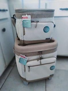 three pieces of luggage stacked on top of each other in a kitchen with white cabinets