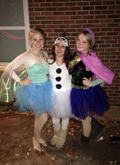 three girls dressed up in costumes posing for the camera