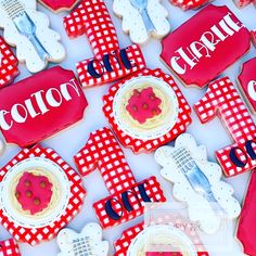 red and white decorated cookies are arranged on a table