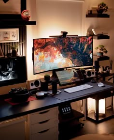 a computer desk with a large monitor and keyboard on it