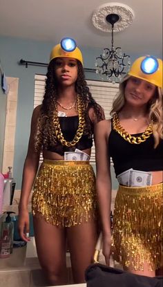 two women wearing gold sequins and matching hats