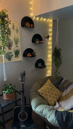 a guitar sits in the corner of a room with plants and lights on the wall