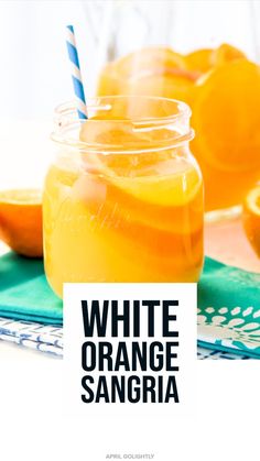 an orange sangria in a mason jar with a blue and white striped straw next to it