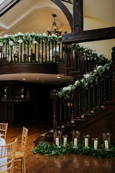 a staircase decorated with greenery and candles