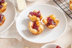 small pastries on plates with butter and jelly