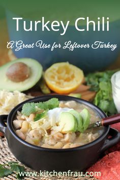 a bowl of turkey chili with avocado and cilantro