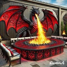 a fire pit with a dragon sitting on it's side and flames coming out