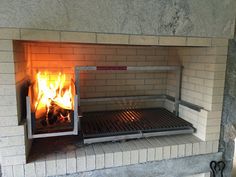 a fire burns in a brick oven