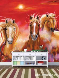 two brown horses standing next to each other in front of a red sunset wall mural