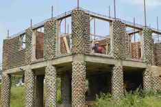 a man standing on top of a wooden structure made out of pineapples