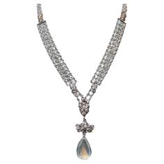 This exquisite and delicate piece is perfect down to the last detail. Dating back to 1910-1920, this rare find has been kept in near perfect t condition. It is hand crafted in platinum and set with natural seed pearls covering every portion. In the section where diamonds are present, the metalwork is platinum topped and 18K backed which was a very typical method for the period. It has been set with approximately 1.25cttw in F-G Vs1-2 clarity original old mine cut diamonds and finished with an ap Streamline Art, Edwardian Era, Seed Pearl, Victorian Jewelry, Dark Beauty, Drop Necklace, White Stone, Metal Working, Moonstone